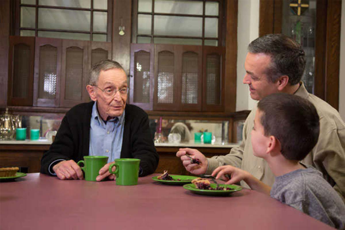 Grandfather telling stories to son and grandson