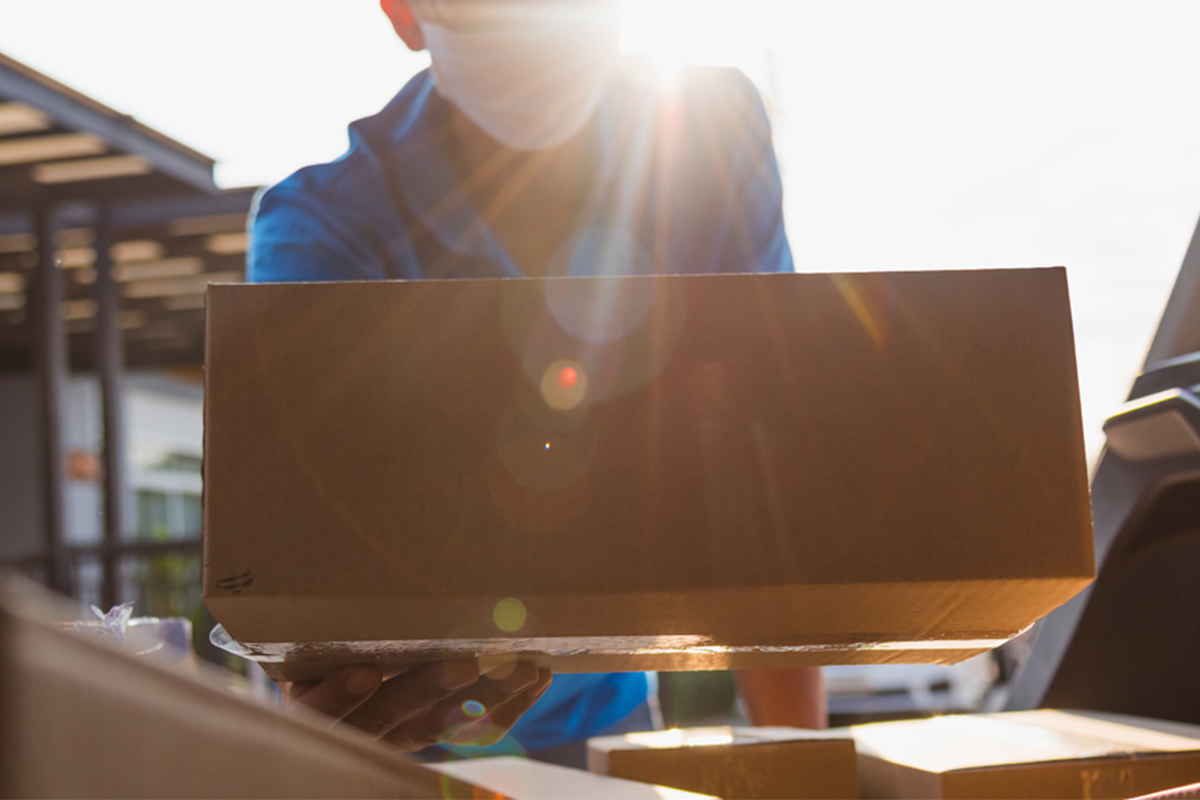 Delivery Man putting package in truck