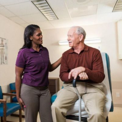 caregiver assisting senior client at the doctors office