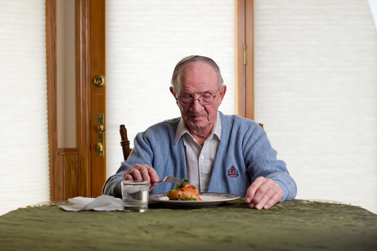 Senior eating alone