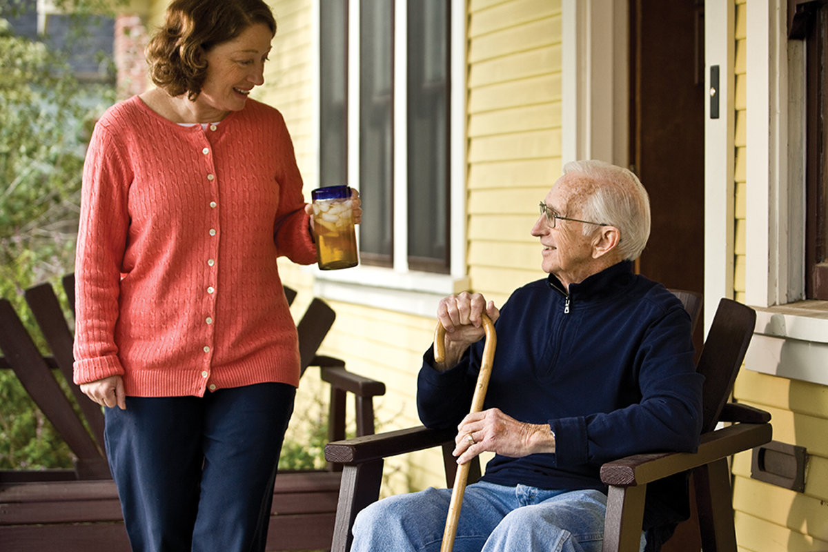 Caregiver offering tea to a senior