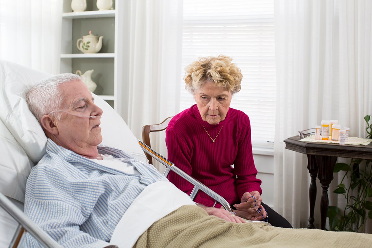 Senior man in hospital bed