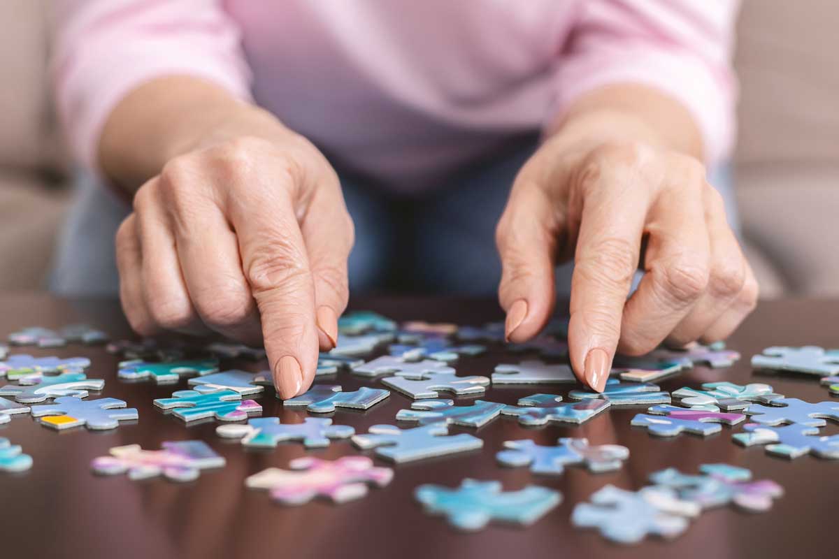 Senior lady completing a puzzle