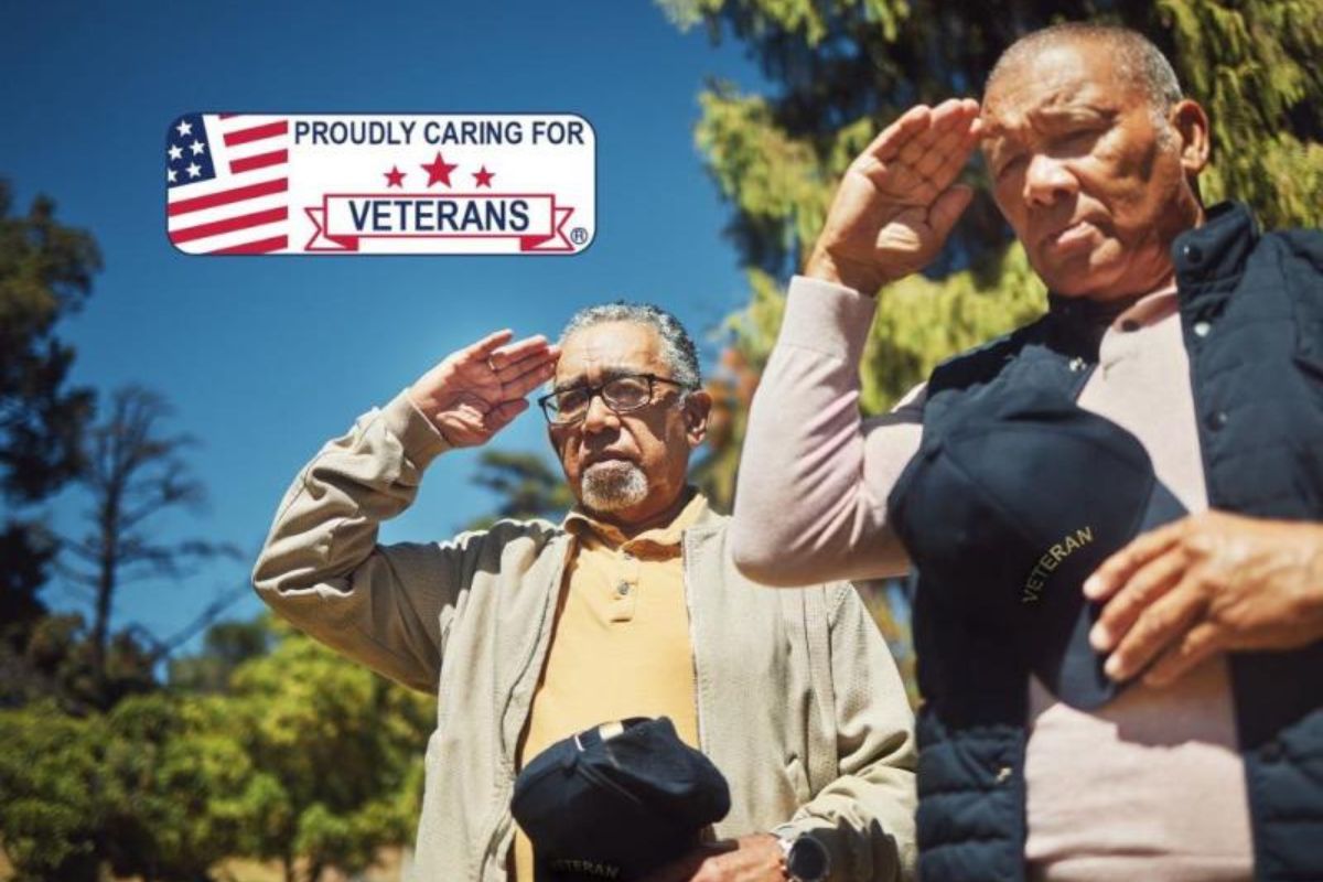 two proud veterans with caps off saluting
