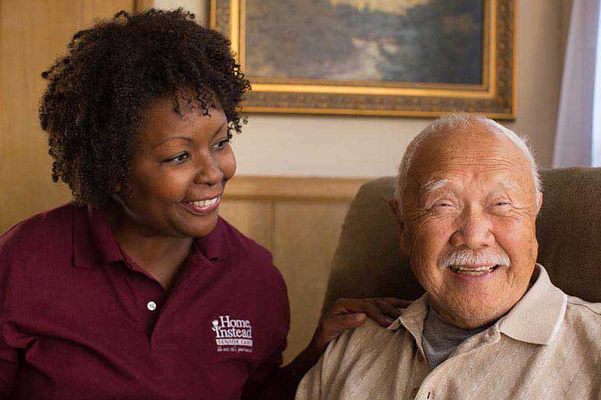 Smiling senior talking to a caregiver