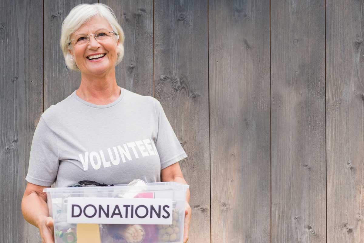 Happy senior enjoying volunteer work and helping others