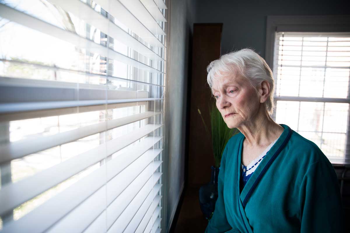 A lonely and sad woman by the window