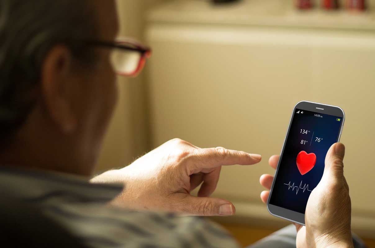Senior using an app to monitor his blood pressure
