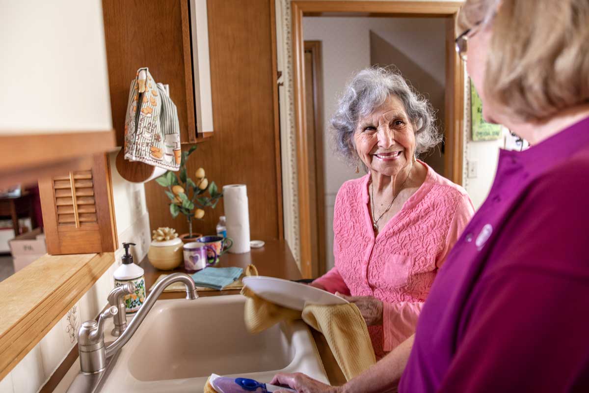 Smiling granmother talking to her caregiver