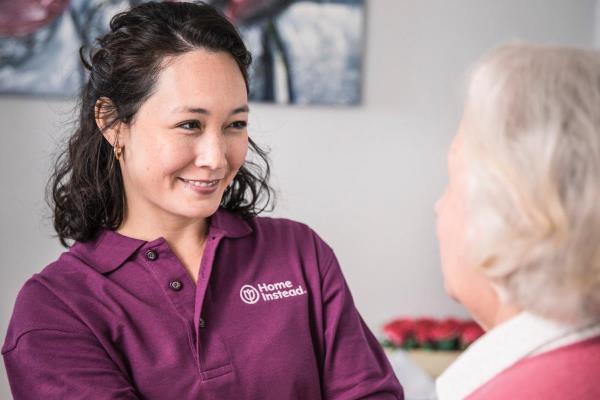 Caregiver Smiling at an Alzheimer's Client