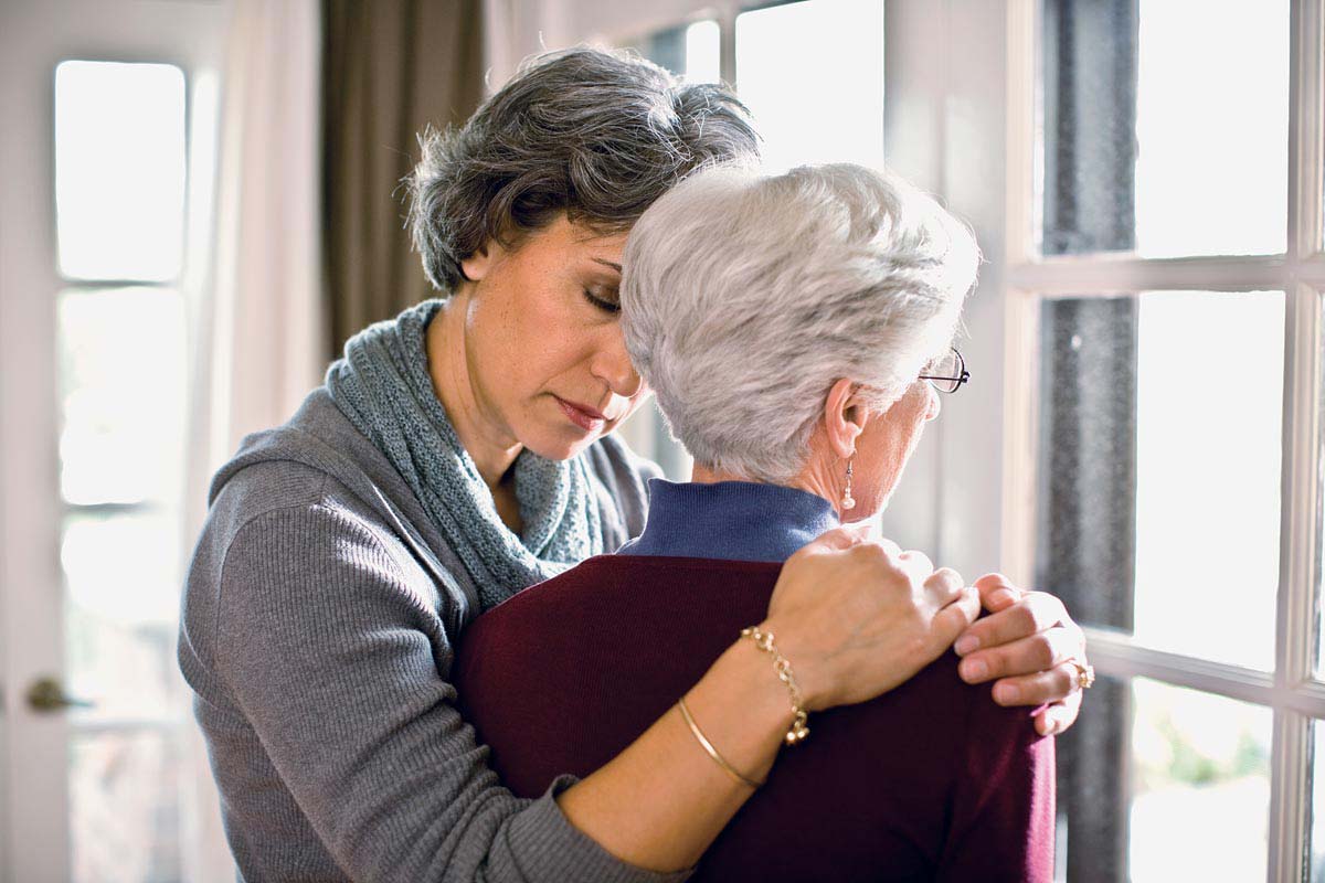 Daughter embracing sad mom