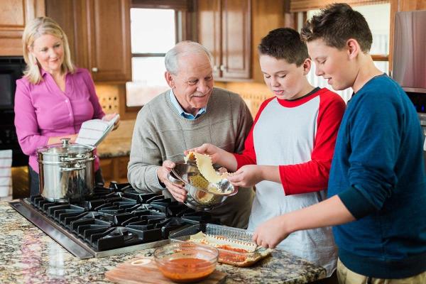 Family cooking with elderly loved one