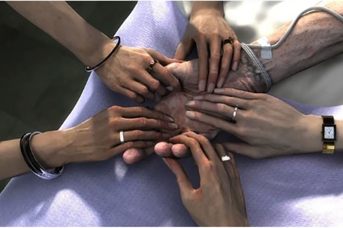 Photo of a ring of loved ones hands holding onto an elderly loved ones hand with a background of a medical bed