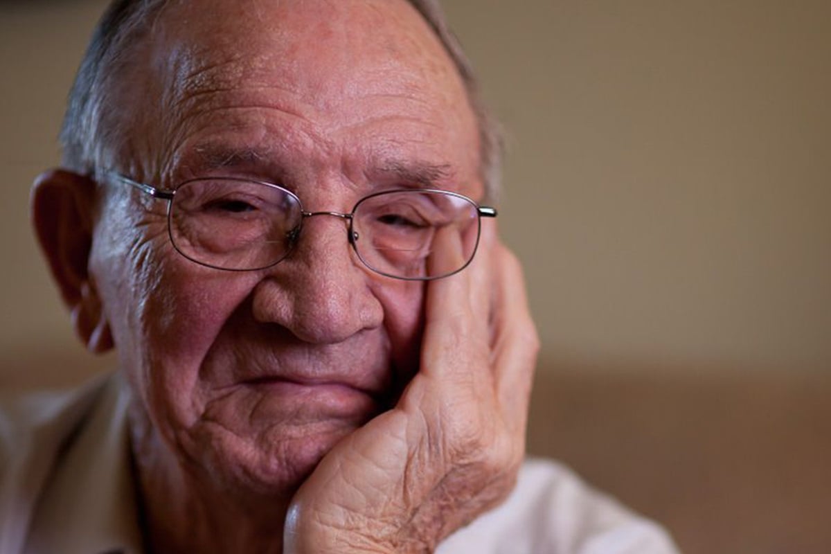 Senior resting his head on his hands