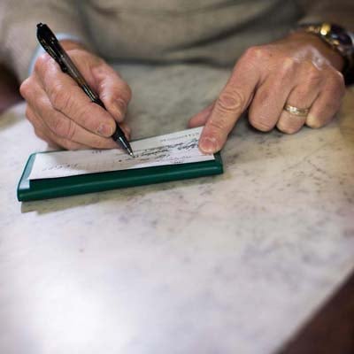 senior balancing his bank account