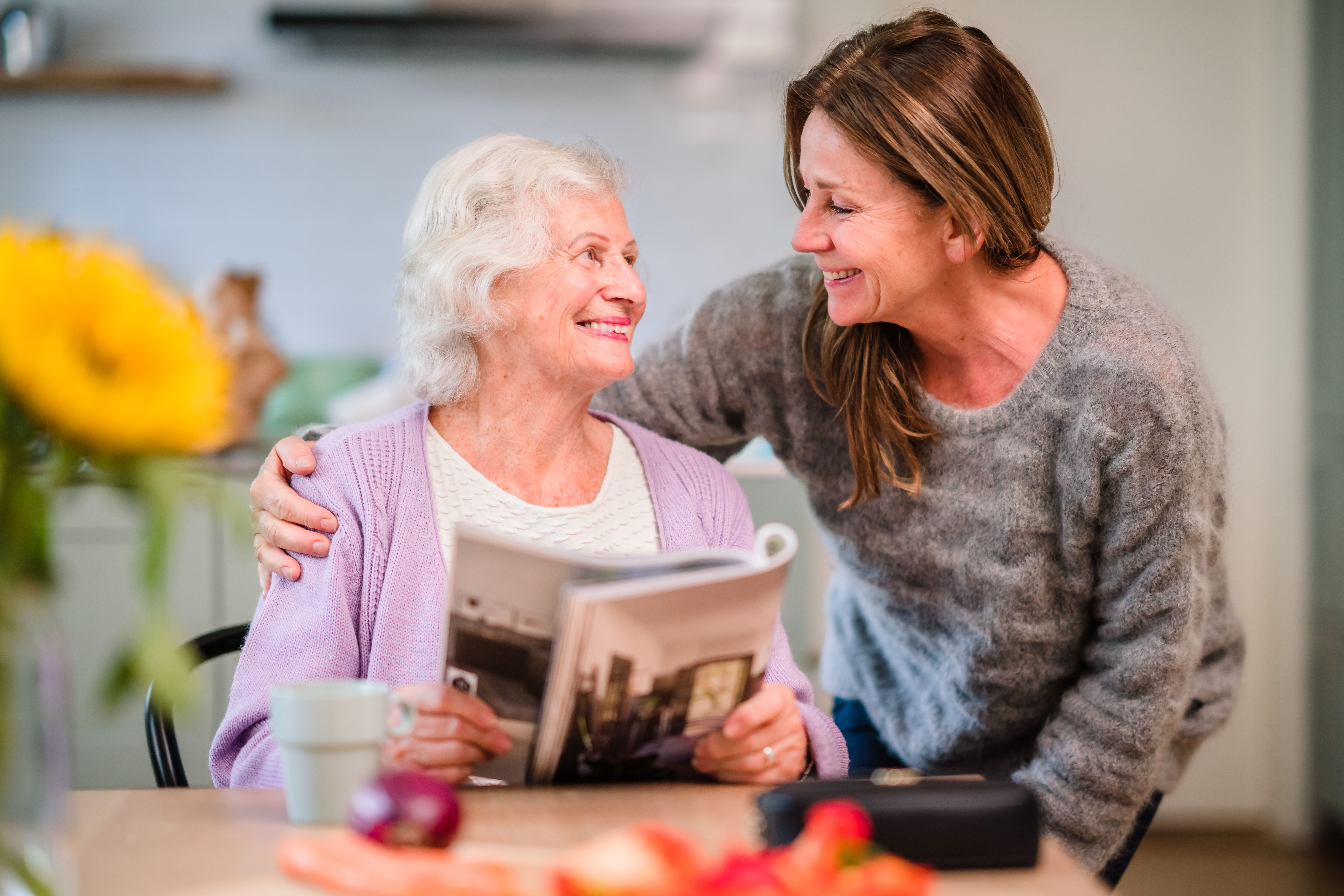 senior woman reads magazine caregiver