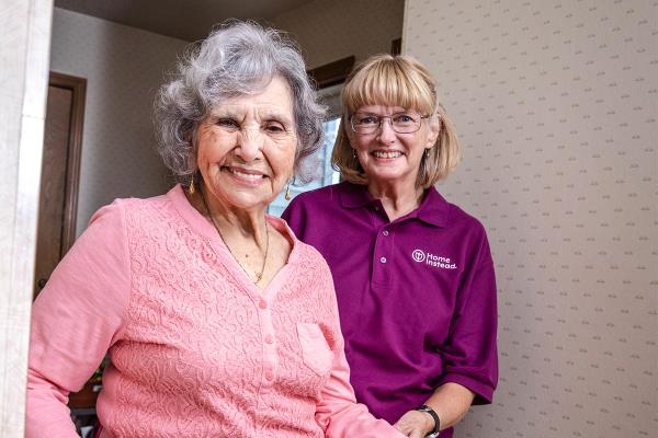 Home Instead CAREGiver Standing with Senior Smiling