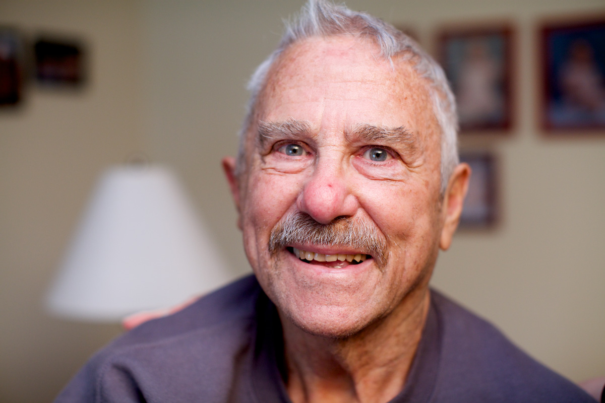Senior man smiling in home.